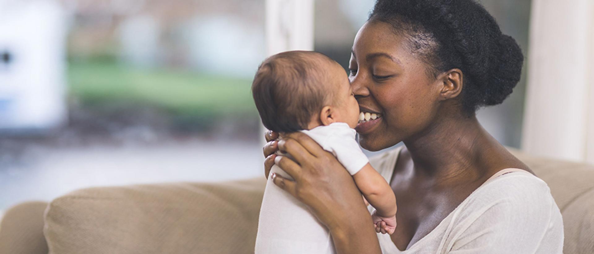 A woman is holding her baby